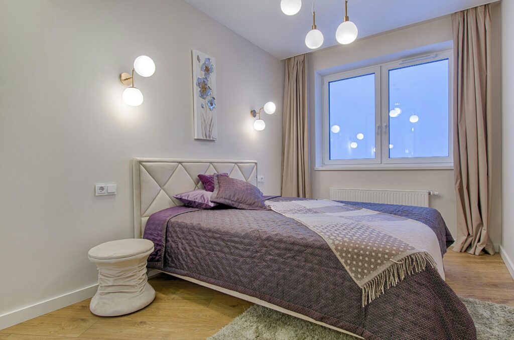 Stylish modern bedroom with purple accents and elegant lighting.